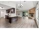 Open-concept living room boasting a fireplace and seamless transition to the kitchen with nice flooring at 1071 Sweet Tree Ct, Apopka, FL 32712