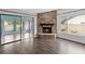 Cozy living room area showcasing brick fireplace with modern windows and sliding glass door at 1071 Sweet Tree Ct, Apopka, FL 32712