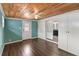 Charming room with wood-paneled ceiling, wooden floors, and bright blue walls at 1071 Sweet Tree Ct, Apopka, FL 32712