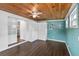 Bright room with wooden ceiling, blue walls, and built-in storage at 1071 Sweet Tree Ct, Apopka, FL 32712