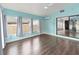 Bright sunroom with wood-look floors, blue walls, and multiple windows that provide natural light at 1071 Sweet Tree Ct, Apopka, FL 32712