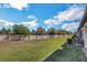 Wide backyard featuring a brick wall with a side view of the home at 1117 Pavia Dr, Apopka, FL 32703