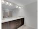 Bright bathroom featuring double sink vanity, large mirror, and tiled shower at 1117 Pavia Dr, Apopka, FL 32703