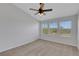 Spacious bedroom with three windows, carpeted floors and a ceiling fan at 1117 Pavia Dr, Apopka, FL 32703