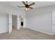 Bedroom with fan and bathroom, featuring neutral paint and carpet at 1117 Pavia Dr, Apopka, FL 32703