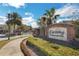 Welcoming entrance to the 'Crossing at Emerson Park' community, featuring brick signage and lush landscaping at 1117 Pavia Dr, Apopka, FL 32703