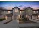 Beautiful townhome exterior with neutral paint, garage, and manicured landscaping at dusk at 1117 Pavia Dr, Apopka, FL 32703
