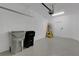 Spacious two car garage with gray epoxy floors, bright lighting and white brick walls at 1117 Pavia Dr, Apopka, FL 32703