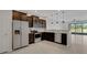 Modern kitchen featuring stainless steel appliances, dark cabinets and an open concept at 1117 Pavia Dr, Apopka, FL 32703