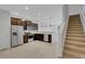Spacious open kitchen with dark wood cabinets, stainless steel appliances, and tiled floors at 1117 Pavia Dr, Apopka, FL 32703
