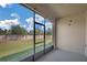 Screened-in lanai with views of the fenced-in yard and a sunny sky at 1117 Pavia Dr, Apopka, FL 32703