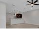 Open-concept room with kitchen view, pendant lights, neutral walls, and tile floors at 1117 Pavia Dr, Apopka, FL 32703