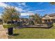 Community playground area with green grass, a slide, and a fenced perimeter for added safety at 1117 Pavia Dr, Apopka, FL 32703