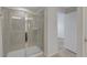Tiled shower with glass door and chrome hardware, next to an open doorway at 1117 Pavia Dr, Apopka, FL 32703