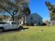 Exterior shot of condo building featuring manicured landscaping and a white pickup truck at 1324 S Pine Ridge Cir # D2, Sanford, FL 32773