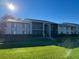 Exterior of condo featuring a green lawn and a walkway to the building entrance at 1324 S Pine Ridge Cir # D2, Sanford, FL 32773