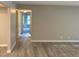 Hallway with light wood-look floors leading to bedrooms and bathrooms at 1324 S Pine Ridge Cir # D2, Sanford, FL 32773