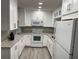 Bright kitchen featuring white cabinets, countertops, and appliances at 1324 S Pine Ridge Cir # D2, Sanford, FL 32773