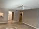 Living room with light wood-look floors, ceiling fan, and view into other rooms at 1324 S Pine Ridge Cir # D2, Sanford, FL 32773