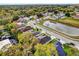 Aerial view of a neighborhood with a pond, lush trees and manicured lawns at 137 Golfside Cir, Sanford, FL 32773