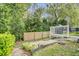 Landscaped backyard featuring a wooden fence, patio with a grill, and a stone pathway at 137 Golfside Cir, Sanford, FL 32773