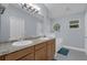 Bright bathroom with a double vanity, granite countertop, and a decorative window for added charm and natural light at 137 Golfside Cir, Sanford, FL 32773