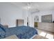 Spacious bedroom with neutral decor, featuring wood-look flooring, a comfortable bed, and ample natural light from the window at 137 Golfside Cir, Sanford, FL 32773