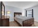 This bedroom features neutral tones, hardwood floors, and a comfy queen bed at 137 Golfside Cir, Sanford, FL 32773