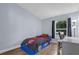 Stylish bedroom with a unique race car bed, a large window, and a functional desk area, perfect for a young car enthusiast at 137 Golfside Cir, Sanford, FL 32773