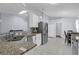 Modern kitchen featuring granite countertops, stainless steel appliances, and white cabinets at 137 Golfside Cir, Sanford, FL 32773