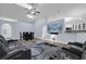 Open-concept living and dining area featuring hardwood floors, modern furniture, and a mounted TV at 137 Golfside Cir, Sanford, FL 32773