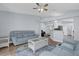 Bright living room with hardwood floors, comfortable blue sofas, and an open layout to the kitchen area at 137 Golfside Cir, Sanford, FL 32773