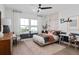 Bedroom with black ceiling fan, large windows and unique wall decor at 15196 Willow Ridge Dr, Montverde, FL 34756