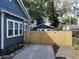 Backyard area with a new wooden fence, a well-kept lawn, and a detached garage at 16 N Lawsona Blvd, Orlando, FL 32801