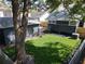 Spacious backyard featuring a well-maintained lawn and a detached garage with a new-looking roof at 16 N Lawsona Blvd, Orlando, FL 32801