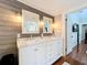 Bathroom featuring a double vanity with marble countertops and decorative wall-mounted lighting at 16 N Lawsona Blvd, Orlando, FL 32801