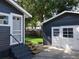 View of the home and detached garage with matching paint, accessible by a concrete driveway at 16 N Lawsona Blvd, Orlando, FL 32801