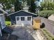 Detached garage with white doors and a small shed nearby, complementing the home's backyard at 16 N Lawsona Blvd, Orlando, FL 32801