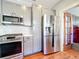 Kitchen features stainless steel appliances, light countertops, and access to the laundry room at 16 N Lawsona Blvd, Orlando, FL 32801