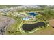 Aerial view showcasing the community pool, lake, and surrounding homes at 17216 Goldcrest Loop, Clermont, FL 34714
