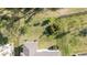 Aerial view of fenced backyard featuring a well-maintained lawn and landscaping at 17216 Goldcrest Loop, Clermont, FL 34714