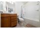 Cozy bathroom featuring vanity, a shower-tub, and tile flooring at 17216 Goldcrest Loop, Clermont, FL 34714