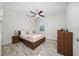Cozy bedroom featuring a ceiling fan, window, and neutral decor at 17216 Goldcrest Loop, Clermont, FL 34714