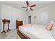 Comfortable bedroom with a ceiling fan, dresser, and a view into the hallway at 17216 Goldcrest Loop, Clermont, FL 34714