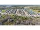 Aerial view of the neighborhood with lush scenery and community lakes at 17216 Goldcrest Loop, Clermont, FL 34714