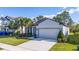 Charming single-story home with a two-car garage, well-manicured lawn, and welcoming curb appeal at 17216 Goldcrest Loop, Clermont, FL 34714
