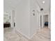Bright hallway with tile flooring leading to various rooms in the home at 17216 Goldcrest Loop, Clermont, FL 34714
