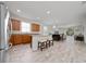Open concept kitchen with stainless steel appliances and island with bar stool seating at 17216 Goldcrest Loop, Clermont, FL 34714