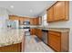 Well-equipped kitchen featuring stainless steel appliances, granite countertops, and tile backsplash at 17216 Goldcrest Loop, Clermont, FL 34714