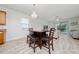 Open living room area with pendant lights, ceiling fan, table with seating and view of exterior patio at 17216 Goldcrest Loop, Clermont, FL 34714